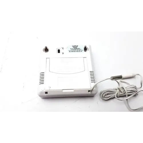 White plastic digital thermometer with coiled gray cable and temperature display switch