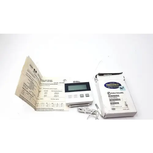 White digital thermostat with a black display screen and four gray buttons, packaged in its original box labeled ’trane’ by fisher & paykel.