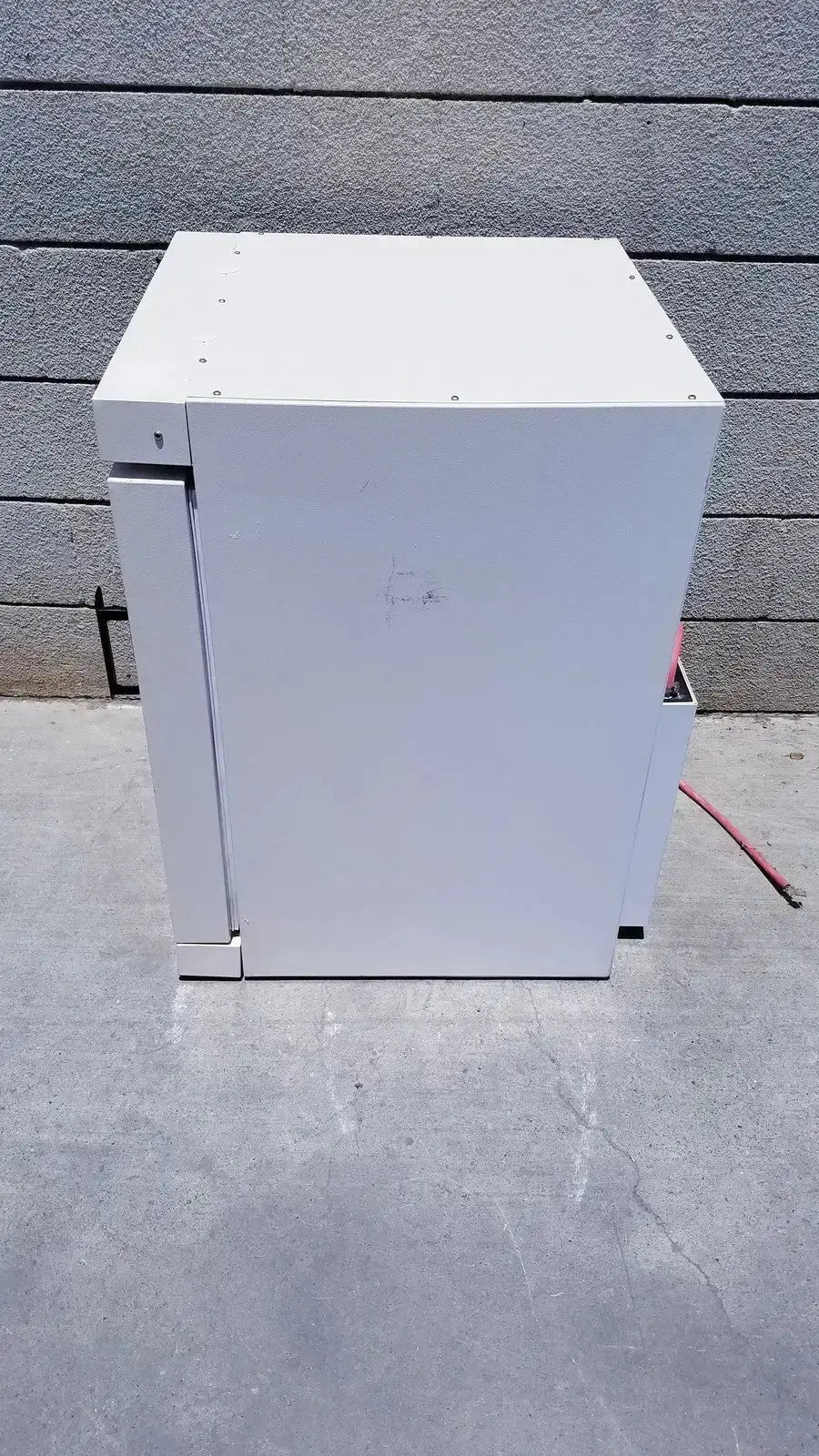 White metal industrial cabinet with hinged door and mounting screws of fisher scientific co2 incubator 116885h