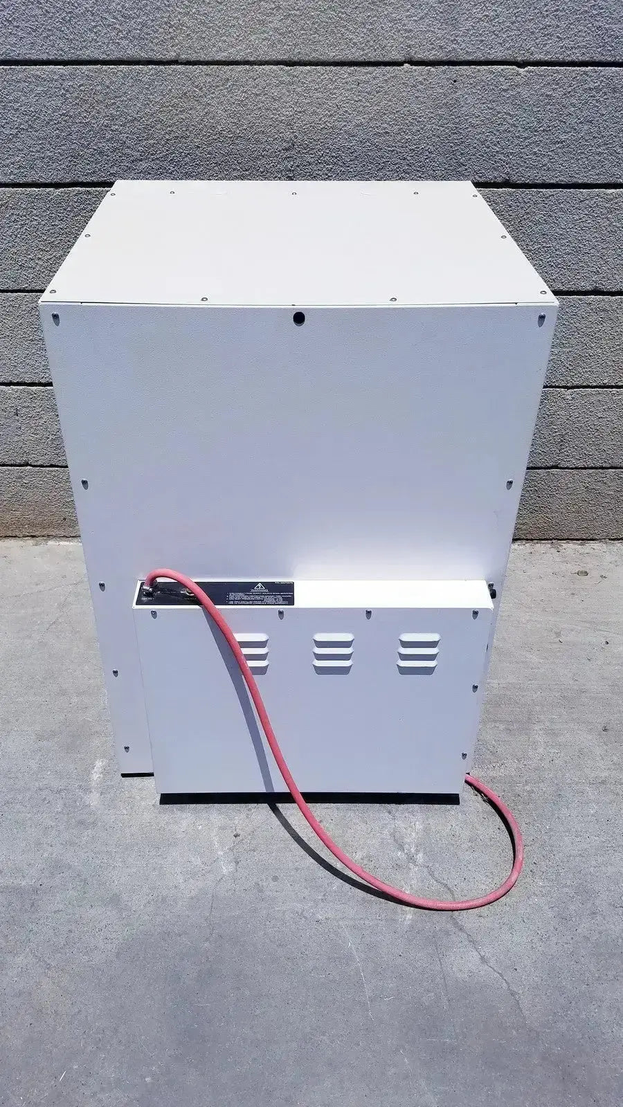 White industrial-grade metal fisher scientific co2 incubator with red power cord and ventilation slots back side view