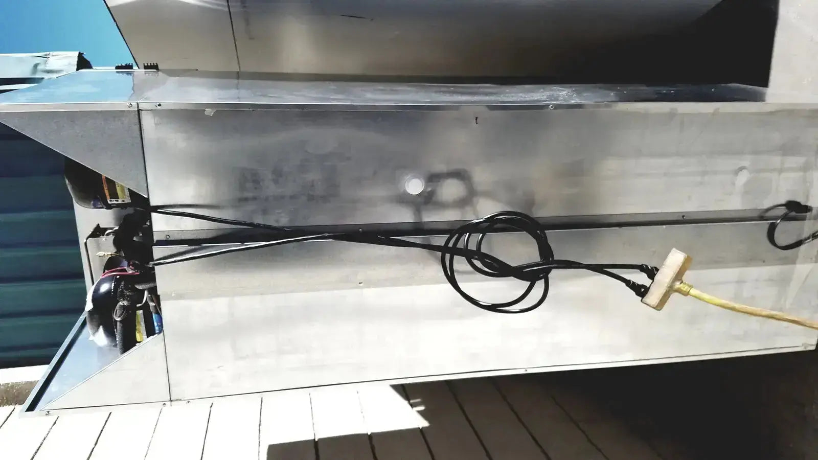 Stainless steel fisher scientific isotemp laboratory freezer refrigerator with black coiled hoses and yellow power cord