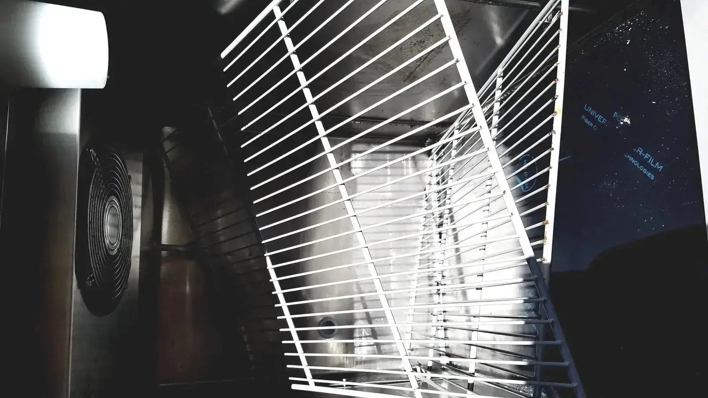 White metal rack with parallel bars inside fisher scientific isotemp laboratory freezer refrigerator for organized storage