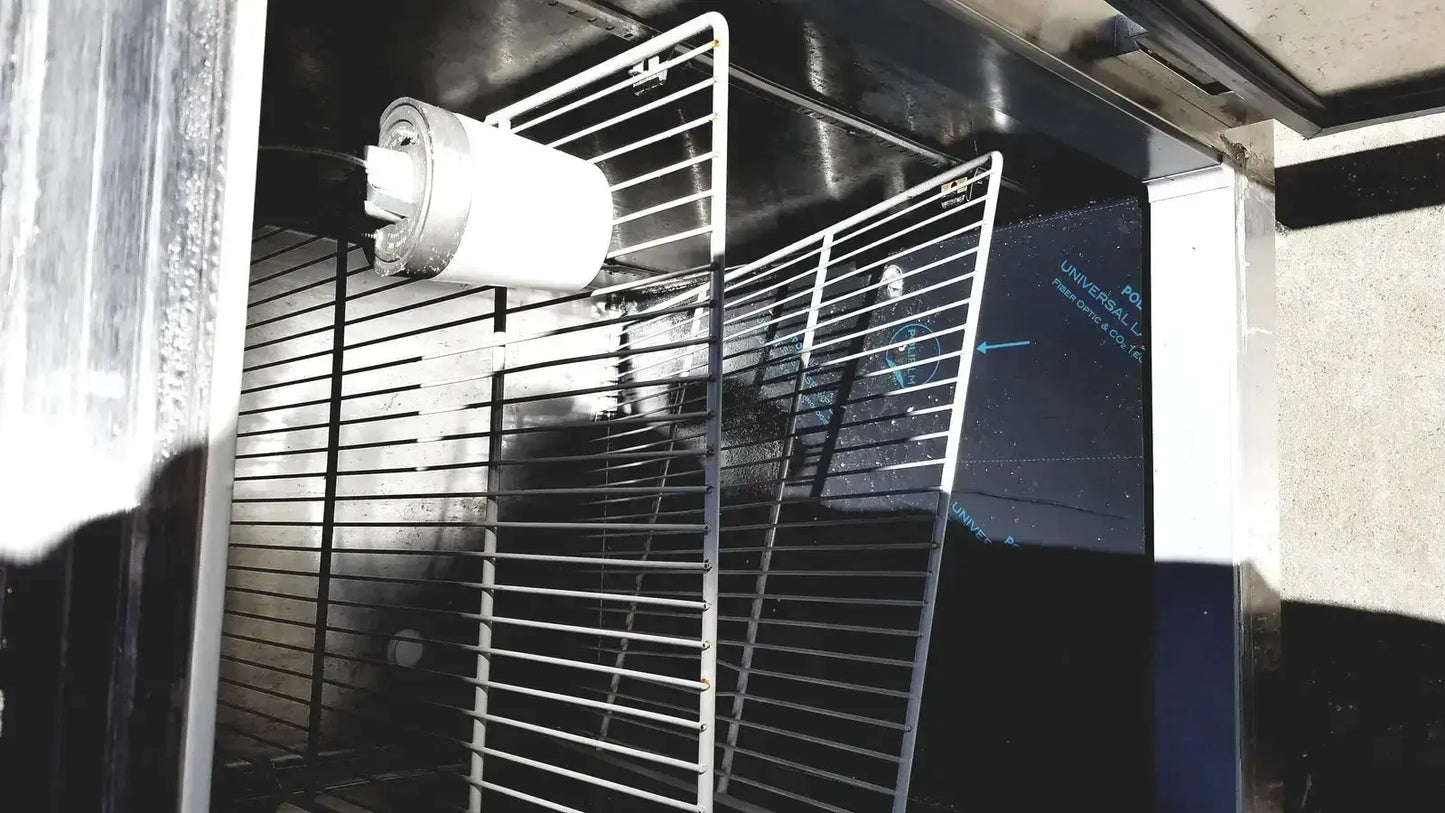 White cylindrical filter mounted on metal rack inside fisher scientific isotemp laboratory freezer refrigerator interior