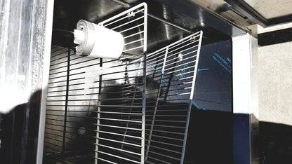 White cylindrical filter mounted on metal rack inside fisher scientific isotemp laboratory freezer refrigerator interior