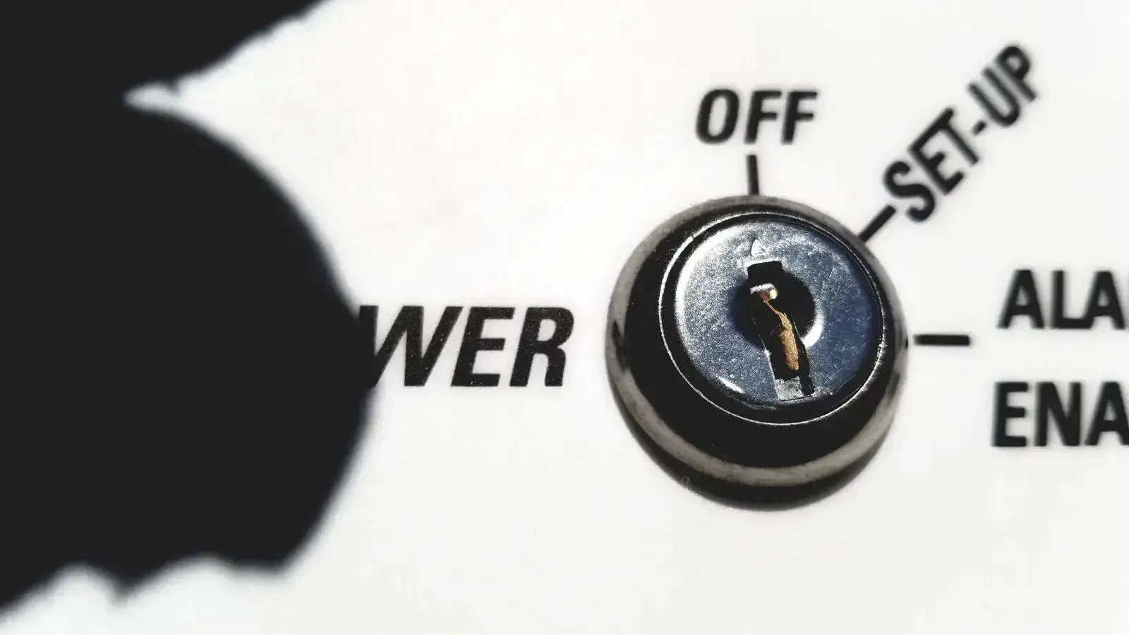 A metallic keyhole with a golden key inserted in the silver circular lock of a Fisher Scientific isotemp laboratory freezer refrigerator