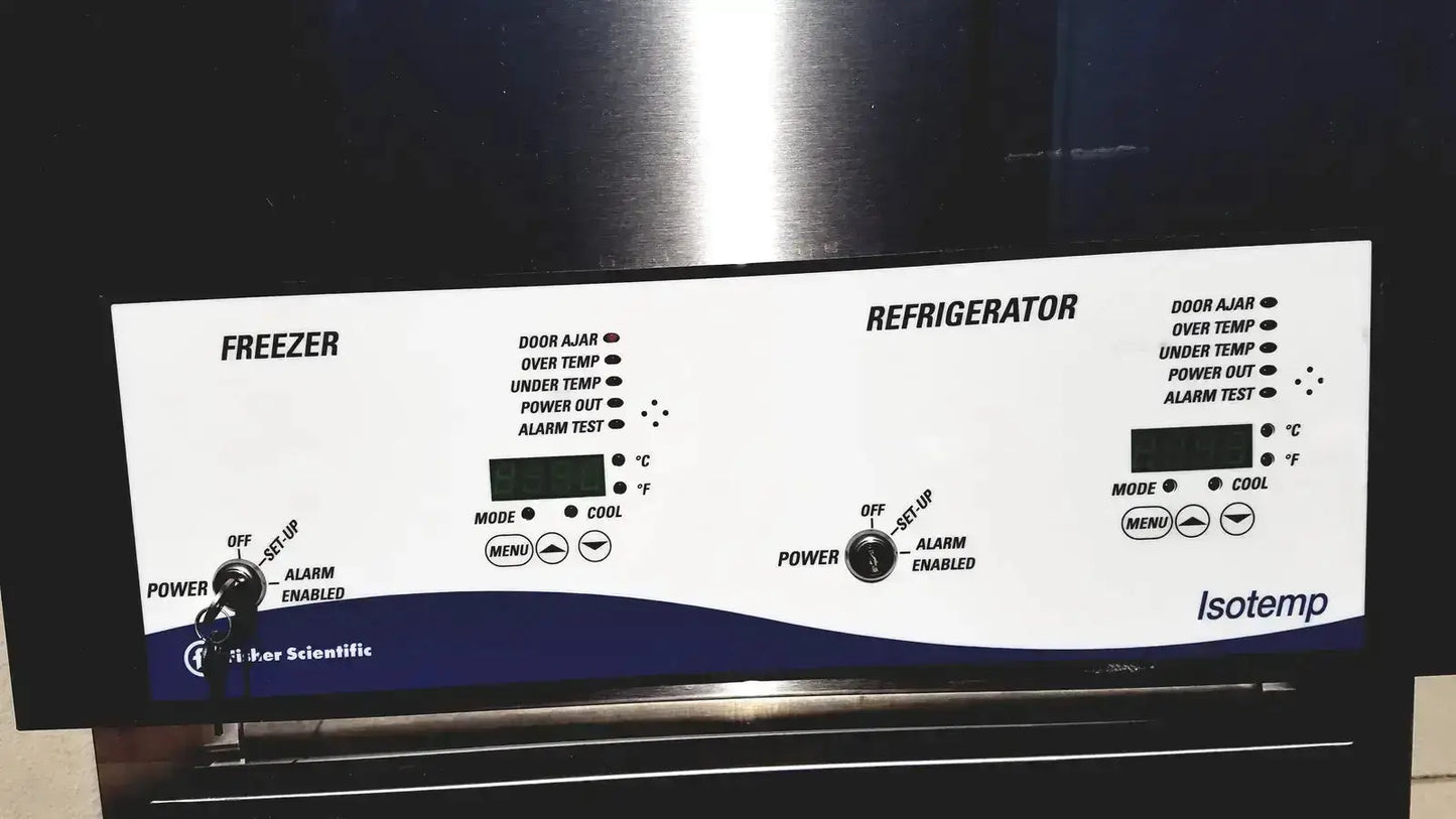 White and blue control panel for Fisher Scientific isotemp laboratory freezer refrigerator with buttons dials and indicator lights