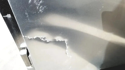 A scratched metallic surface with reflective silver finish on the fisher scientific isotemp laboratory freezer refrigerator