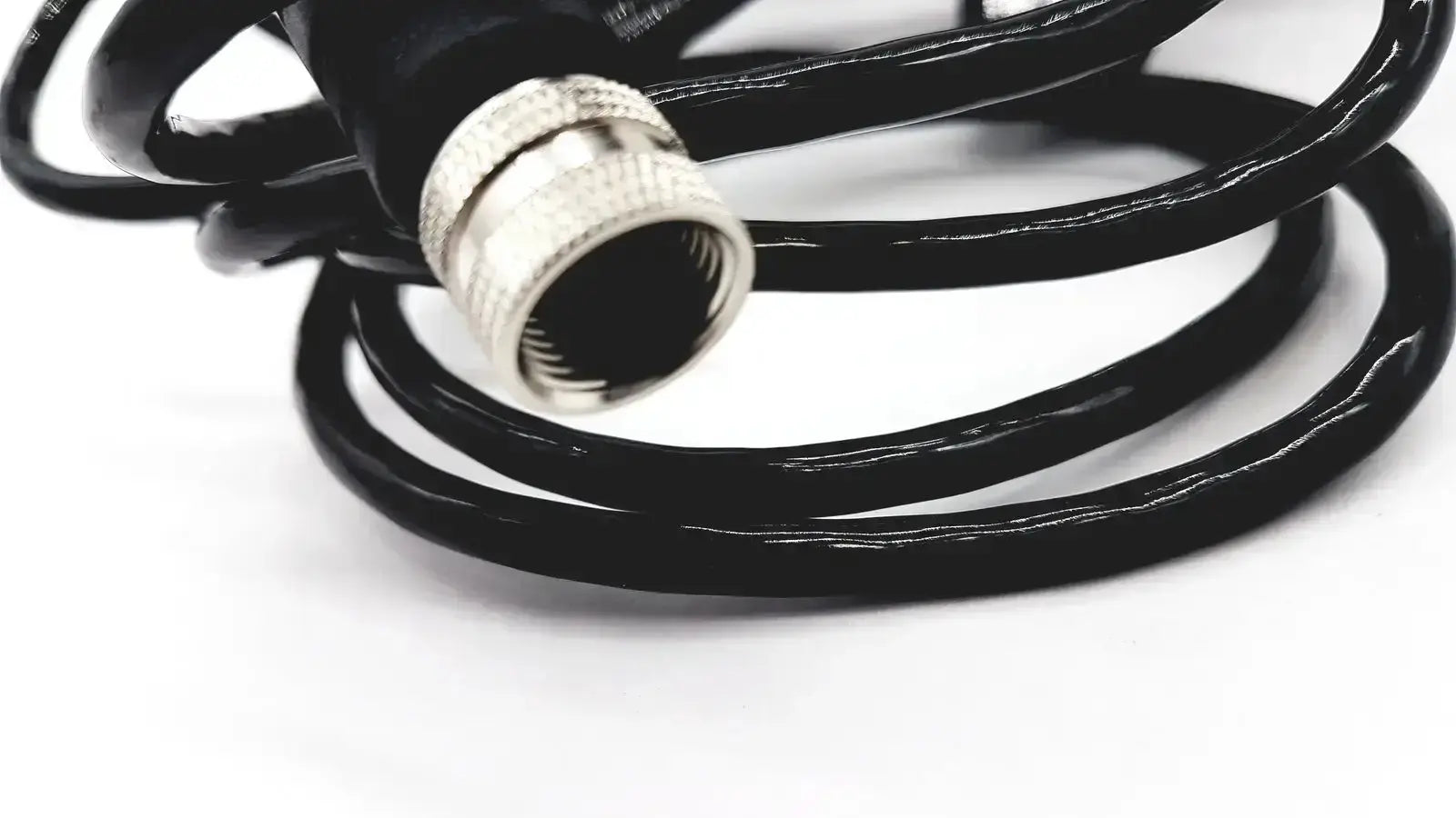 Black coiled cable with silver metallic connector compatible with med-mizer allcare beds for secure connection