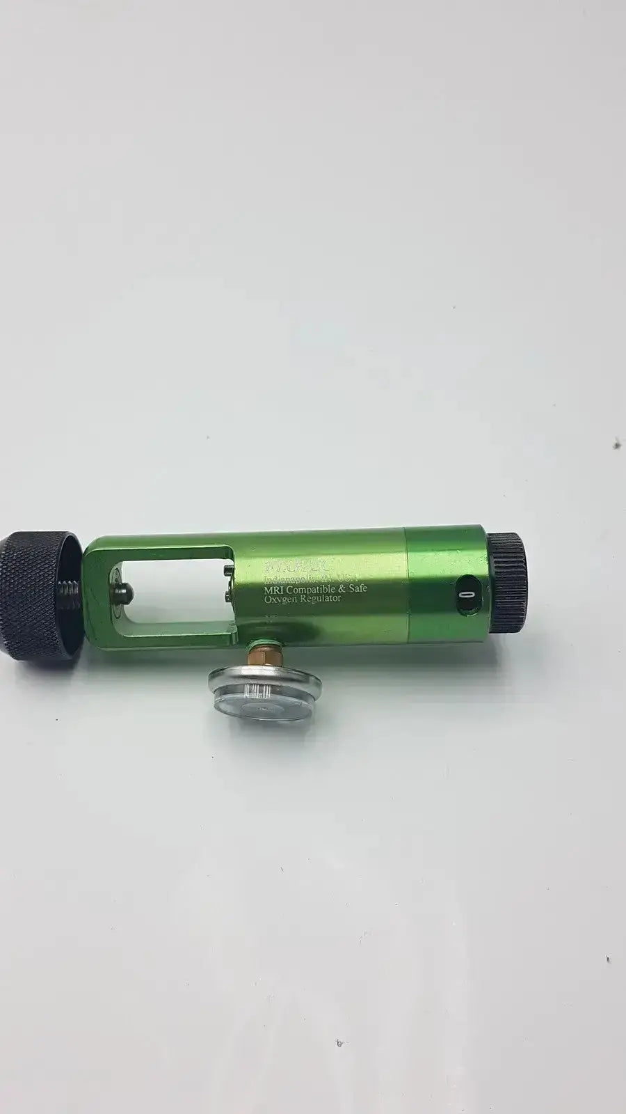 Green metallic cylindrical flotec mri compatible oxygen regulator with black knobs and clear circular center component