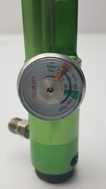 Green cylindrical flotec mri compatible oxygen regulator with silver pressure gauge and multicolor markings for safe use