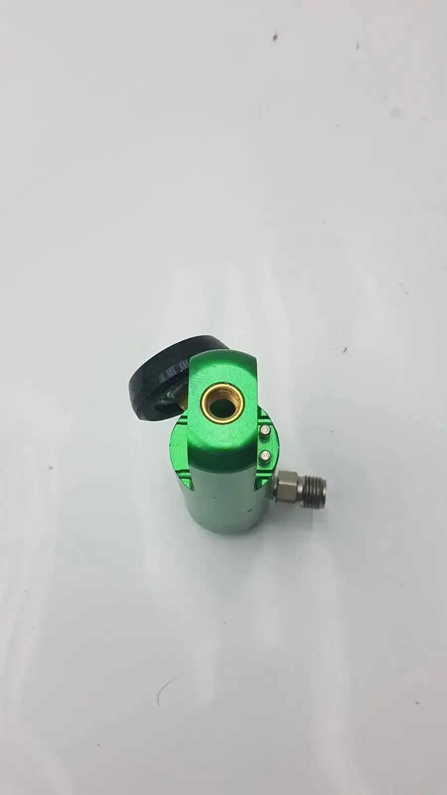 Green metallic tattoo machine with black grip and gold needle housing featured in flotec oxygen regulator used medical equipment for sale
