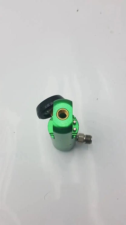 Green metallic tattoo machine with black grip and gold needle housing featured in flotec oxygen regulator used medical equipment for sale