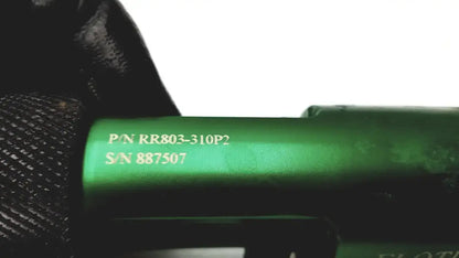 Green cylindrical flotec rr803-310p2 oxygen regulator component with engraved part and serial numbers visible