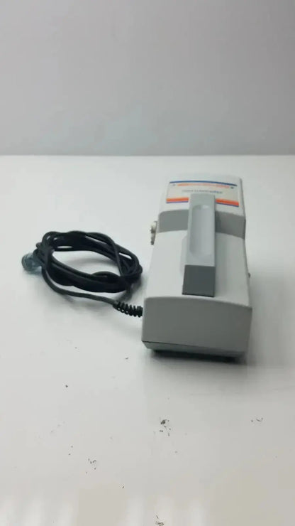 Gray handheld huntleigh flowtron excel device with coiled black cable and orange display panel for excel ac550 replacement
