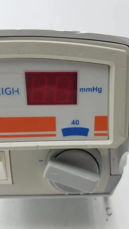 Gray medical infusion pump flowtron excel ac550 with red digital mmhg display and orange blue dial for precise control