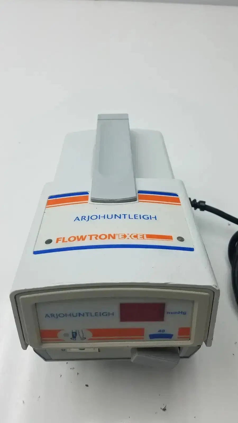 White plastic flowtron excel arjo huntleigh ac550 medical device with orange blue stripes gray handle and digital display