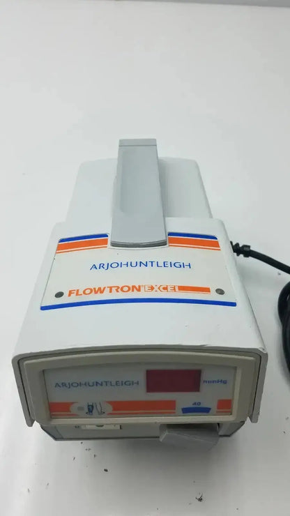 White plastic flowtron excel arjo huntleigh ac550 medical device with orange blue stripes gray handle and digital display