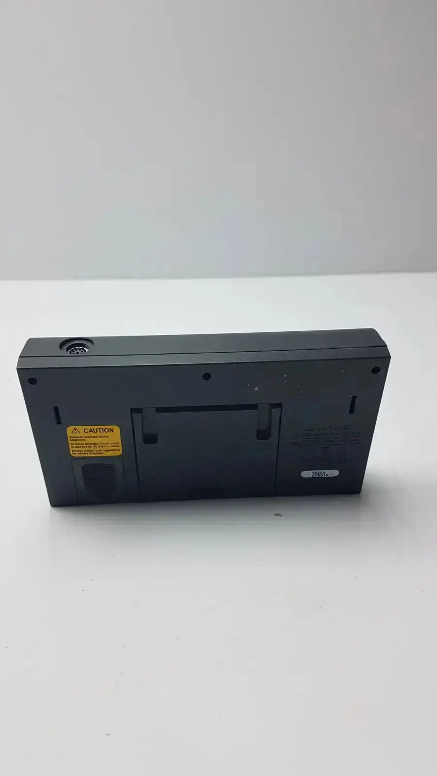 Black rectangular fluke 1620a dewk digital thermometer-hygrometer with yellow caution label and top circular port
