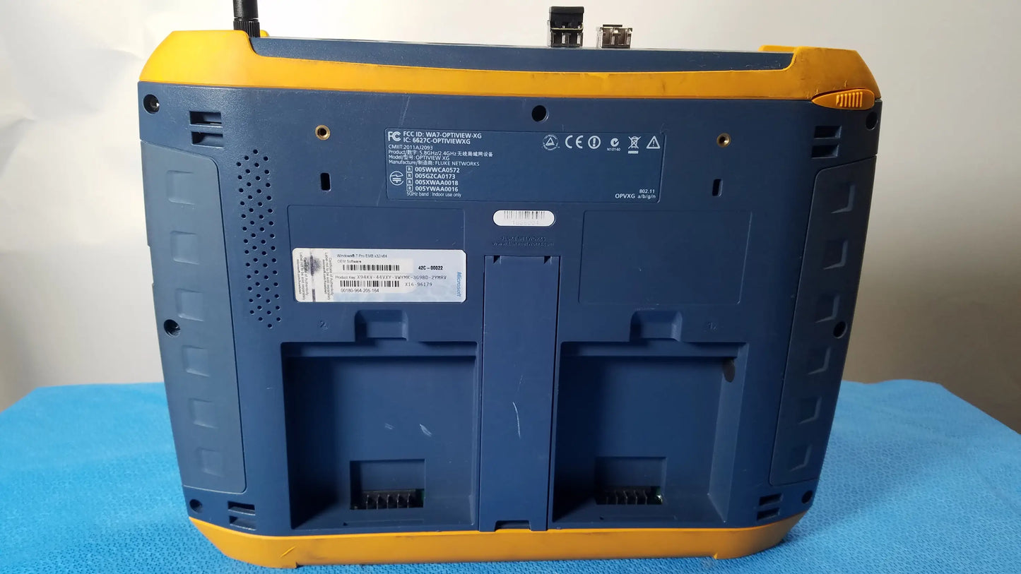 Back of a blue and yellow ruggedized fluke networks optiview xg network analysis tablet with battery compartments and labels