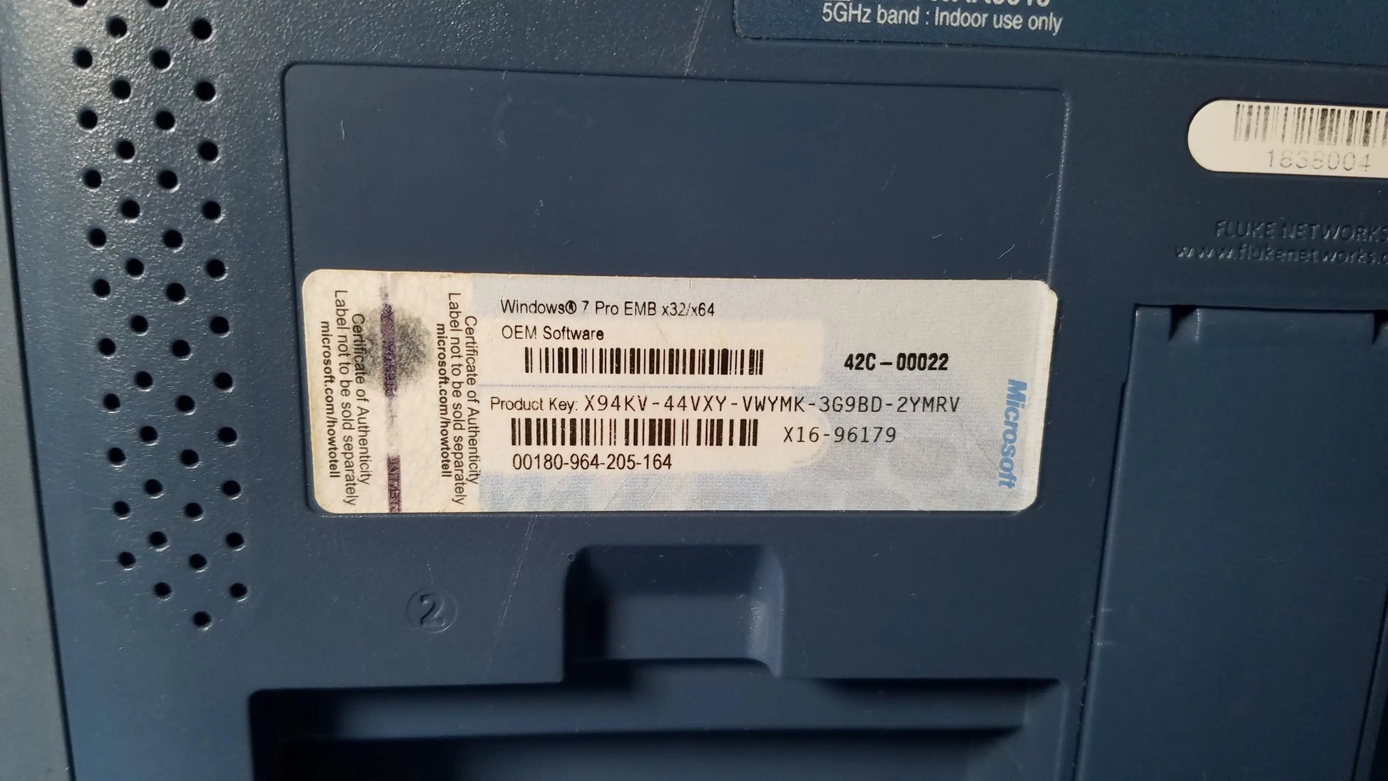 Dark blue plastic back panel of fluke networks optiview xg network analysis tablet with white product information label