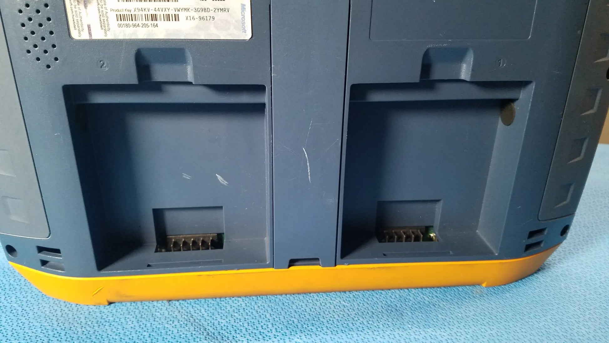 Dark gray and yellow industrial-grade battery charger with dual slots for fluke networks optiview xg network analysis tablet batteries