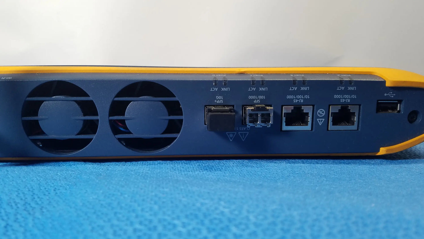 Back side of yellow and blue fluke networks optiview XG network analysis tablet showing ethernet ports usb port and ventilation grilles