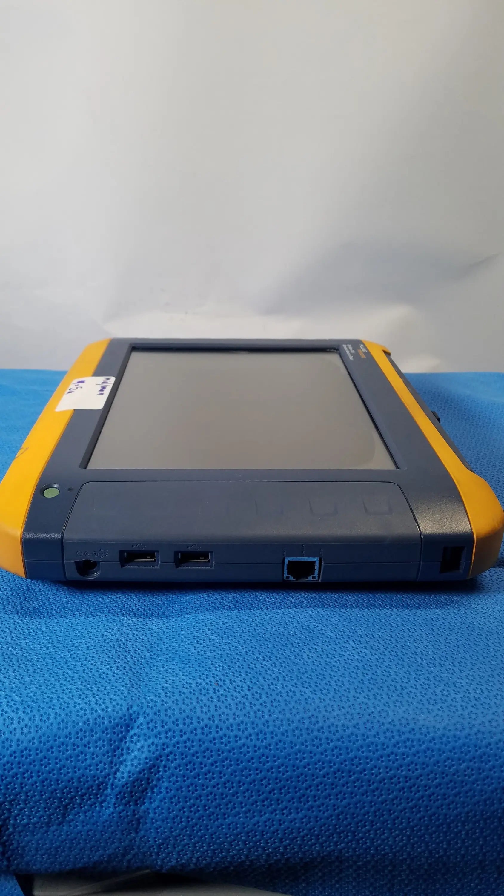 Yellow and gray fluke networks optiview xg network analysis tablet with rugged design and multiple side ports