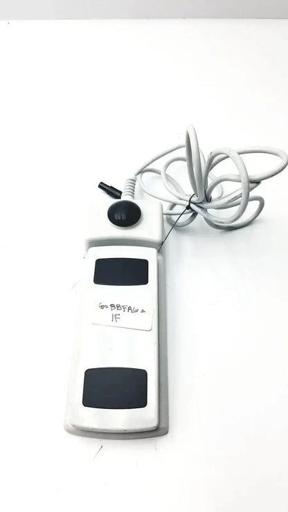 Footswitch w7102106 white plastic foot pedal with black buttons and coiled gray power cable used medical equipment for sale