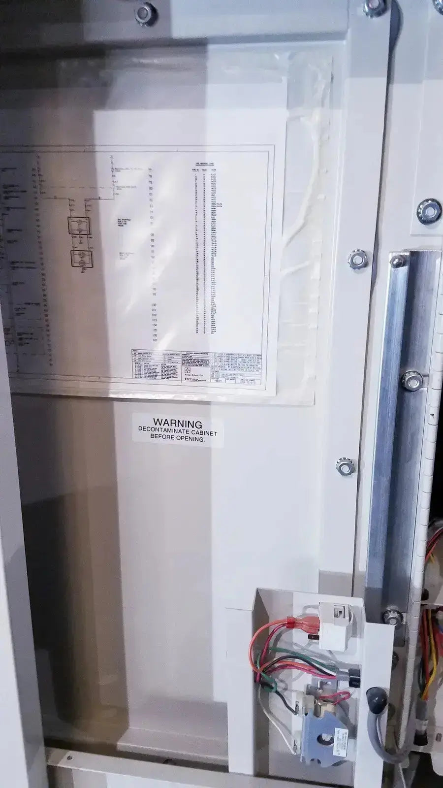 White industrial electrical control panel with warning label and wiring components on forma scientific class II A/B3 biological safety cabinet