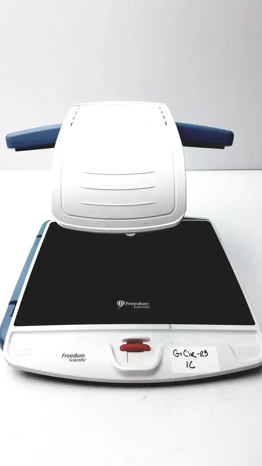 White and blue freedom scientific topaz xl hd regulatory model 10010 scanning device with black glass surface