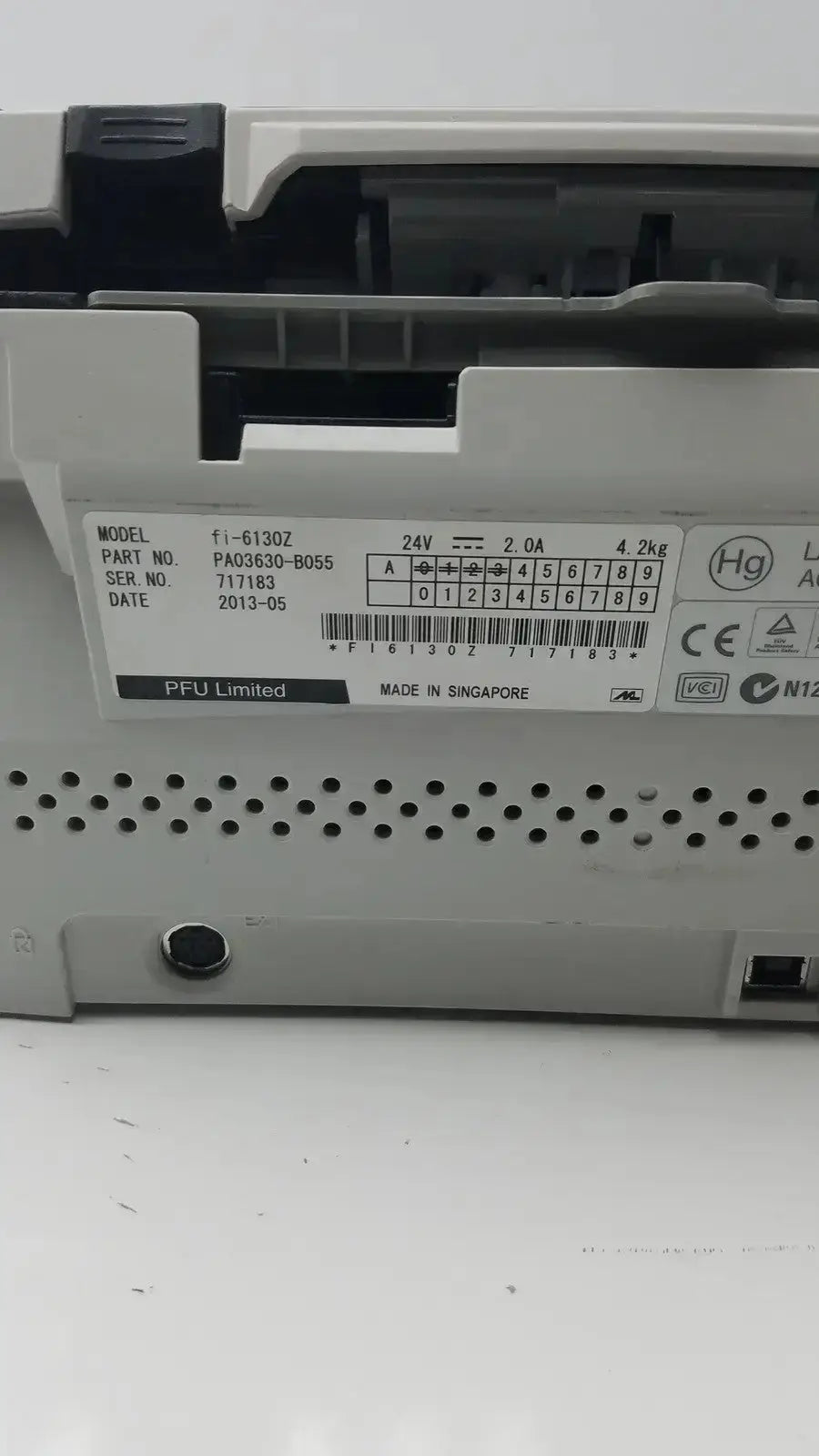 White plastic fujitsu fi-6130z high-speed duplex document scanner control panel with black labeling and ventilation holes