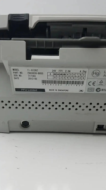 White plastic fujitsu fi-6130z high-speed duplex document scanner control panel with black labeling and ventilation holes
