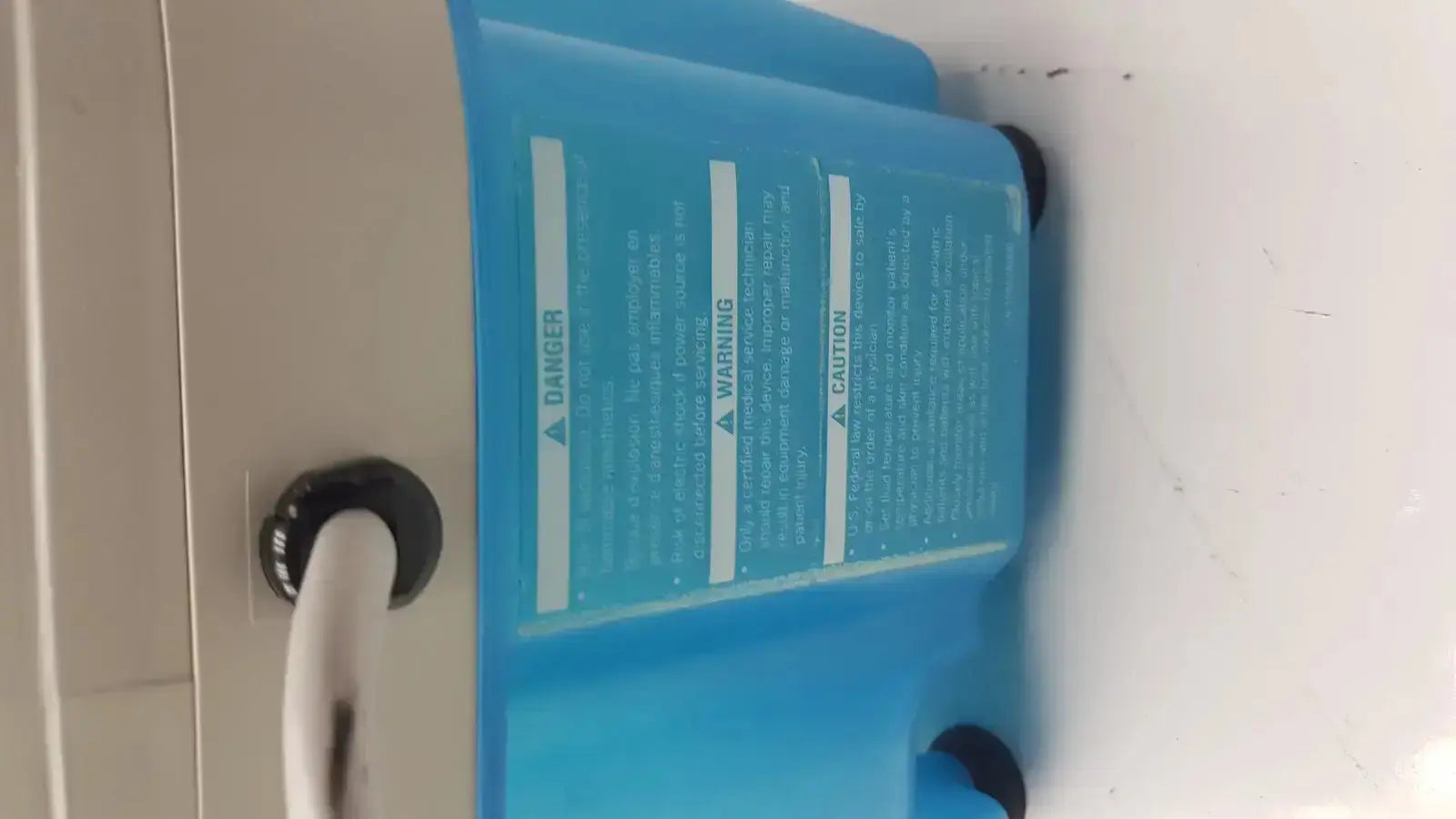Blue plastic Gaymar tpump professional heat therapy pump tp700c with black caps and white tubing attached
