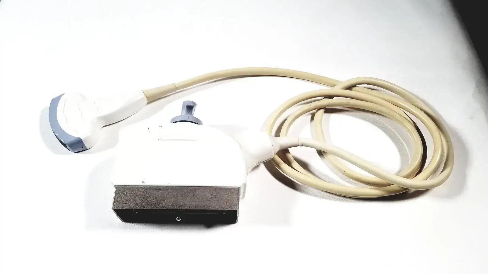 GE 4C convex array ultrasound transducer probe with white and gray ergonomic design and beige cable for ultrasound systems