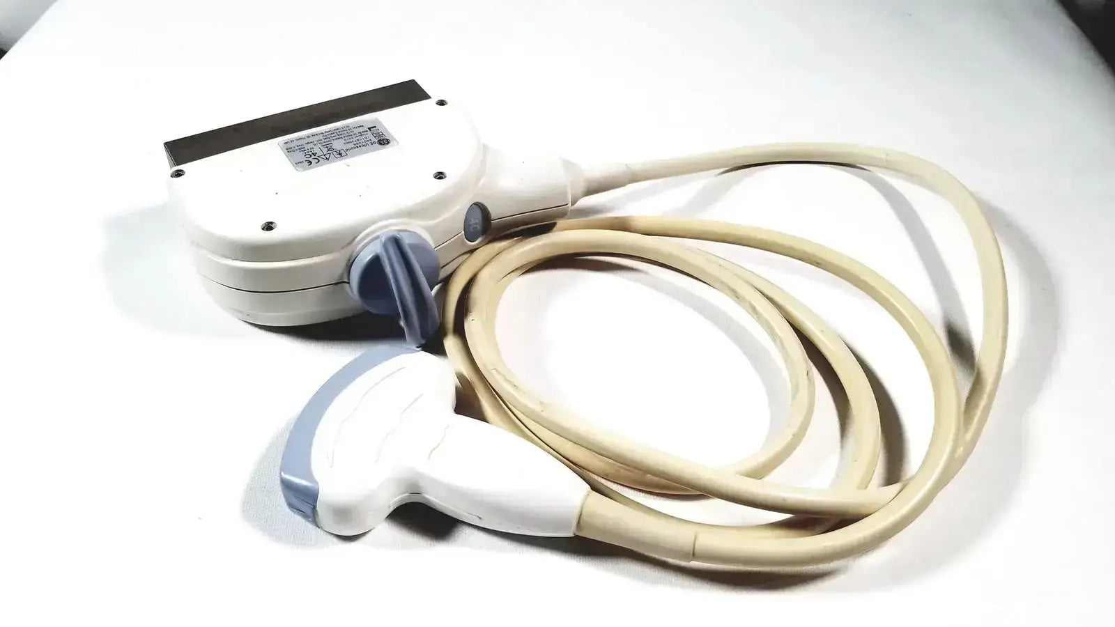 GE 4C convex array ultrasound transducer probe in white and light blue with coiled beige cable for ultrasound systems