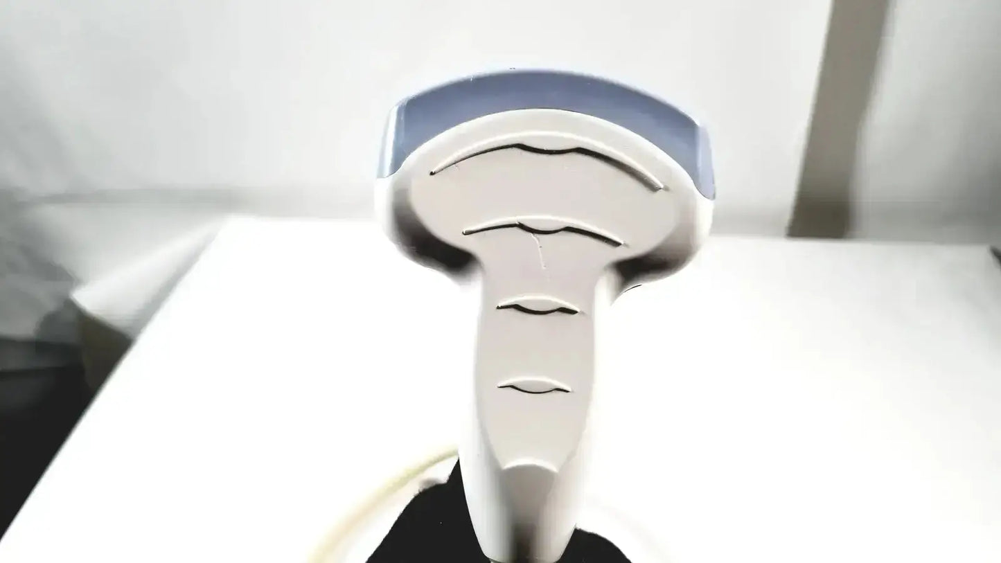 A sleek silver handheld hair straightener with blue accents and multiple slots shown alongside a ge 4c convex array ultrasound transducer probe