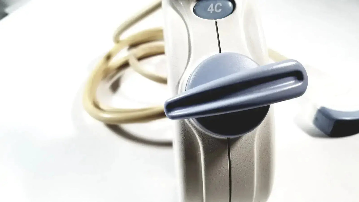 Beige and gray handheld electric hair dryer with circular dial marked 4c for use with convex array ultrasound systems