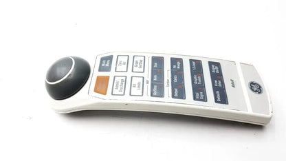 White GE adult solar 8000m 8000i remote control device with a black spherical trackball on the left side