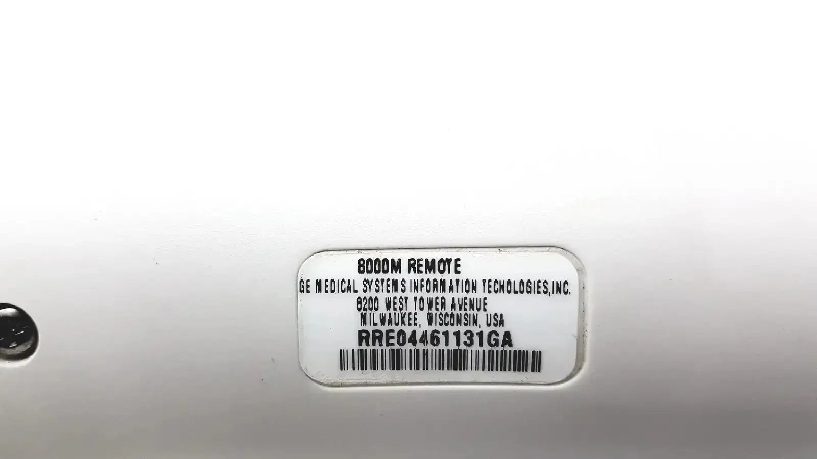 White plastic label with black text and barcode on the back of a ge adult solar 8000m remote control device