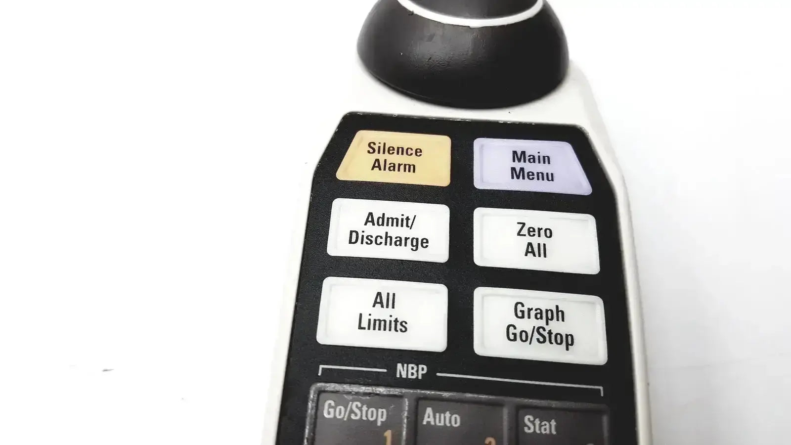 Black and white GE adult Solar 8000M remote control with labeled function buttons including silence alarm and zero all