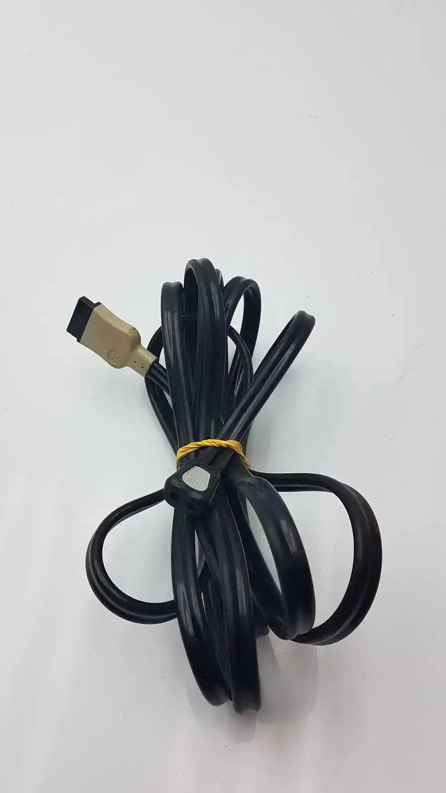 Black hdmi cable with gold connector coiled and secured by yellow tie from ge cable suitable for medical equipment use