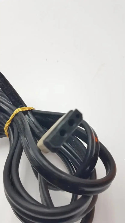 Black coiled GE cable with rectangular three-hole connector and beige housing tied by yellow rubber band for medical equipment