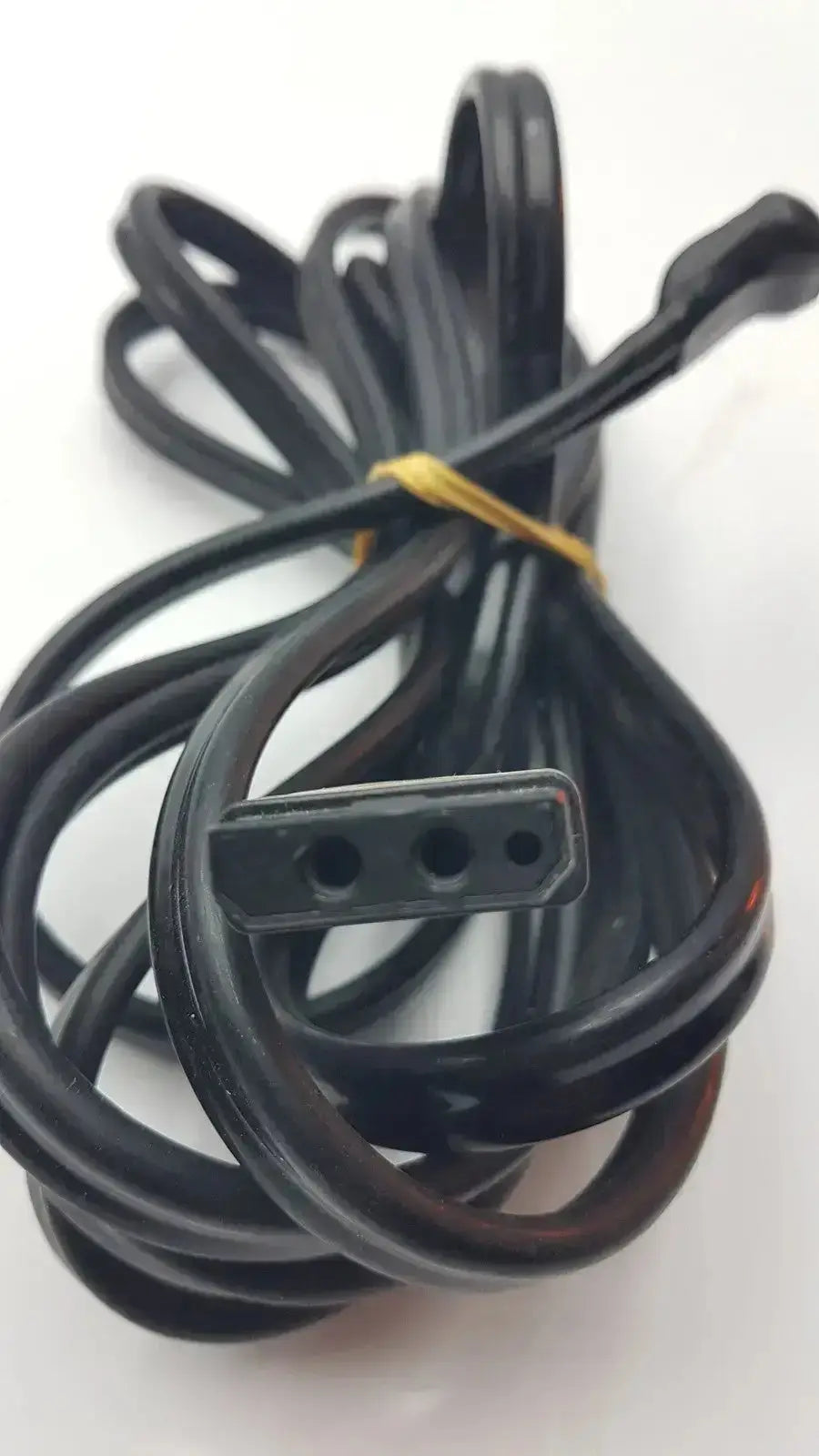 Ge cable black coiled power cord with three-prong plug and yellow tie for hospital surplus medical equipment use