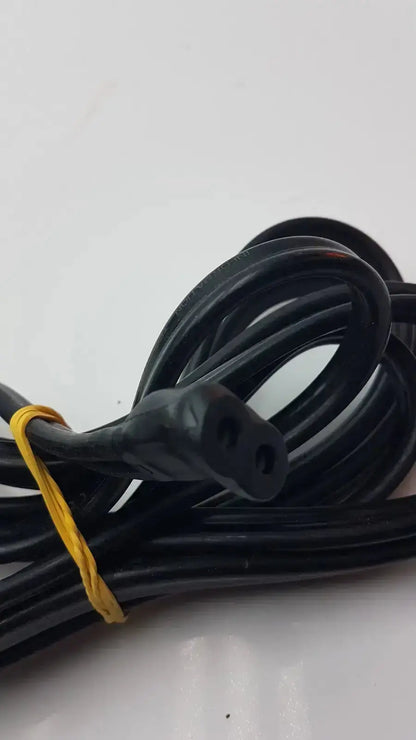 Black coiled GE cable with a two-prong plug and yellow tie for hospital surplus medical equipment use