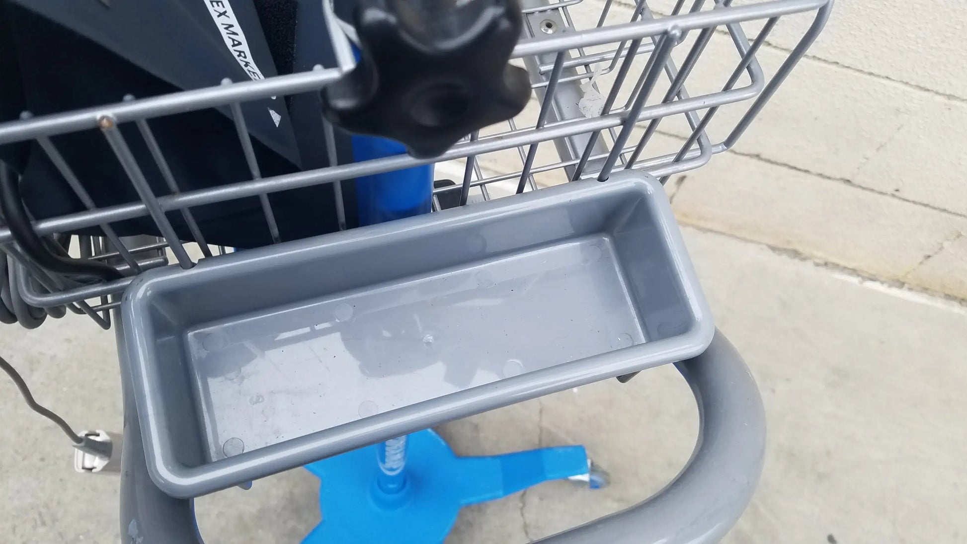 Gray plastic shopping cart tray with shallow rectangular shape and raised edges for reuse medical equipment in dinamap procare dpc