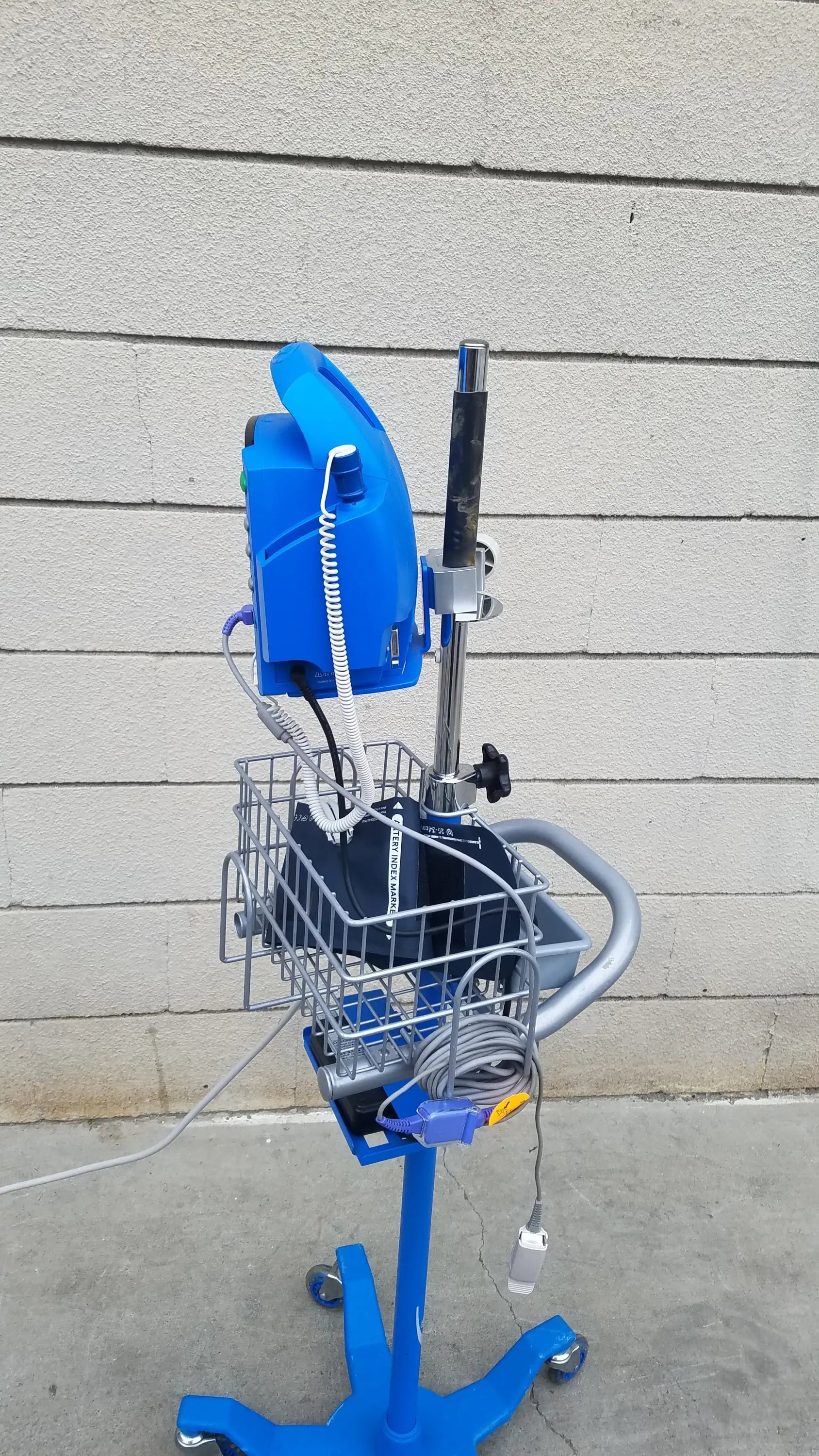 Blue medical cart with wire basket adjustable pole and wheeled base for dinamap procare dpc 400 medical equipment reuse
