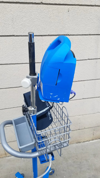 Blue plastic GE Dinamap ProCare DPC 400 vital signs monitor on mobile cart with metal basket gray tray medical equipment