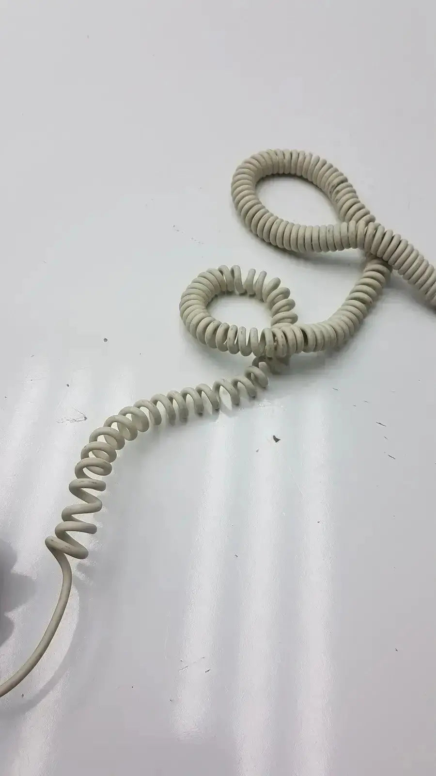 Beige coiled telephone cord with flexible spiral design for ge dragonfly hand switch and light spring