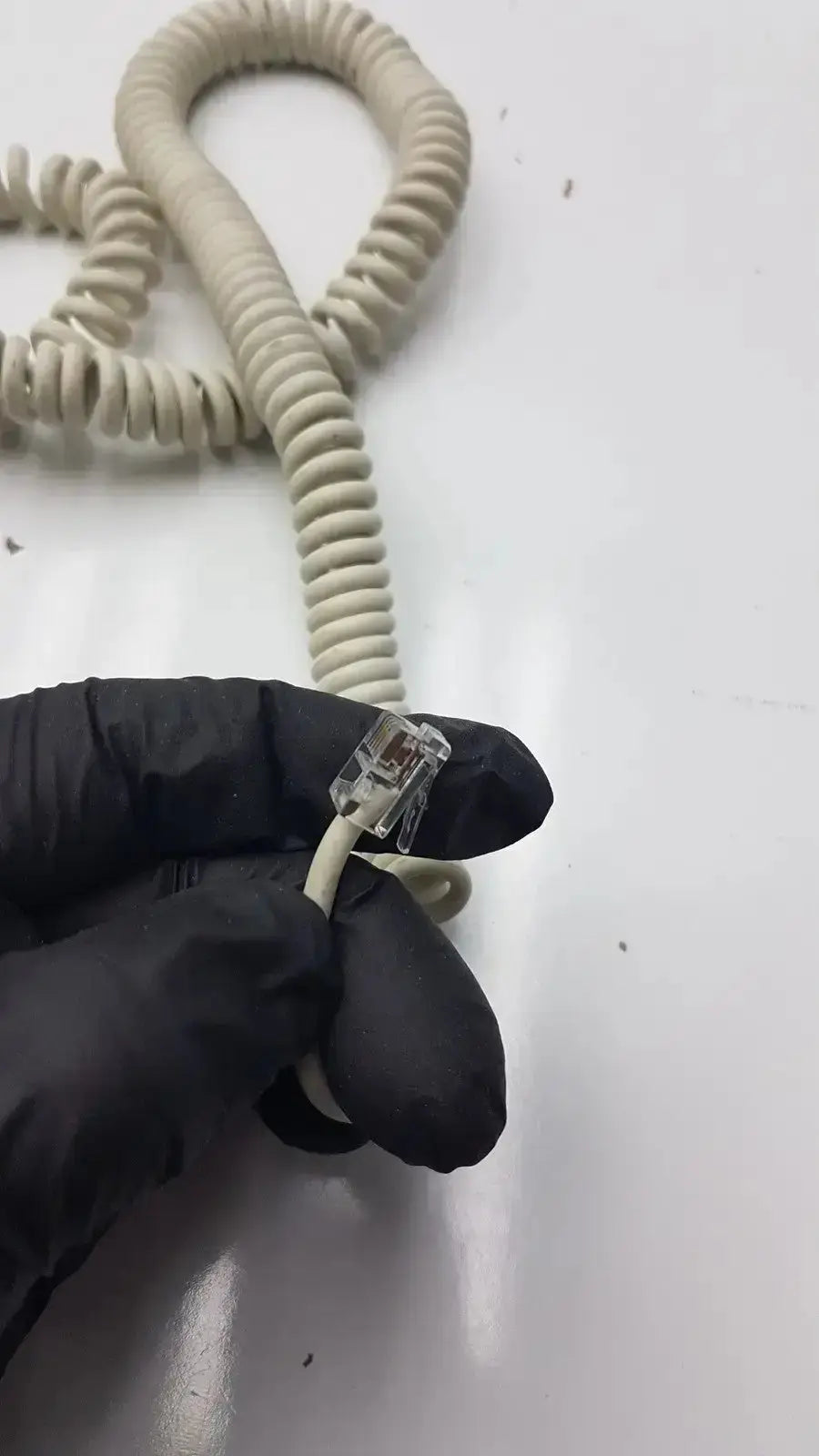 Beige coiled telephone cord with clear plastic rj-45 connector for ge dragonfly hand switch and light spring