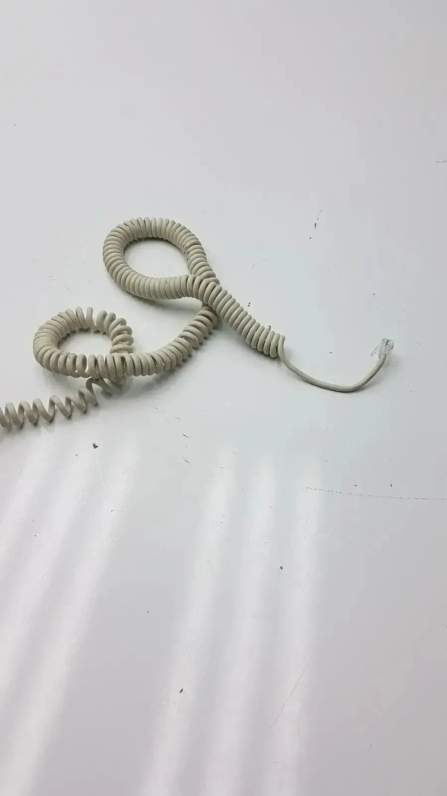 Beige coiled telephone cord with rj-45 connector for ge dragonfly hand switch and light spring hand switch use